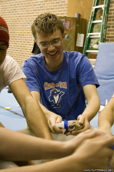 Ted cleans holds at the climbing wall