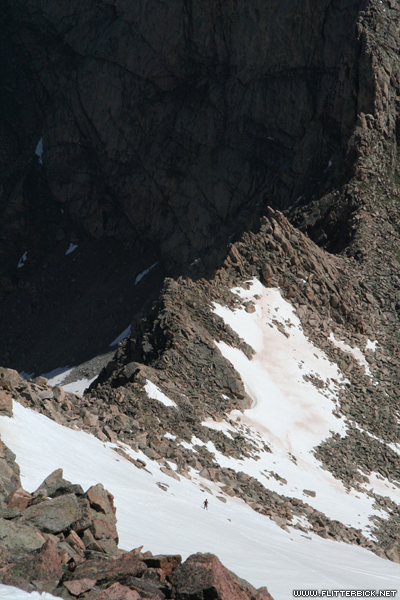 The third-class Sawtooth ridge connects Mt. Bierstadt to Mt. Evans. A lone hiker starts the traverse, bottom center